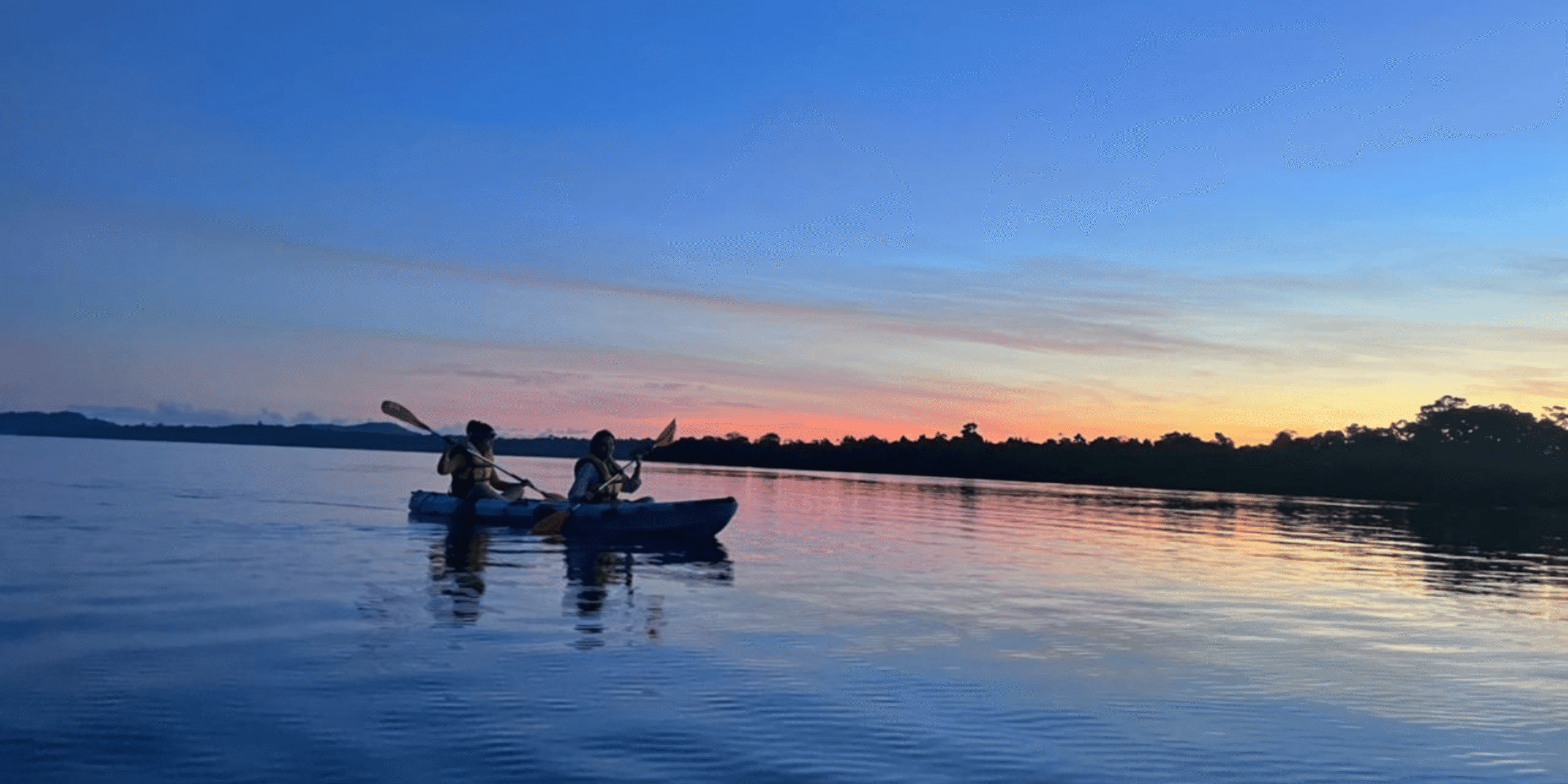 Kayaking on calm Havelock waters at golden hour